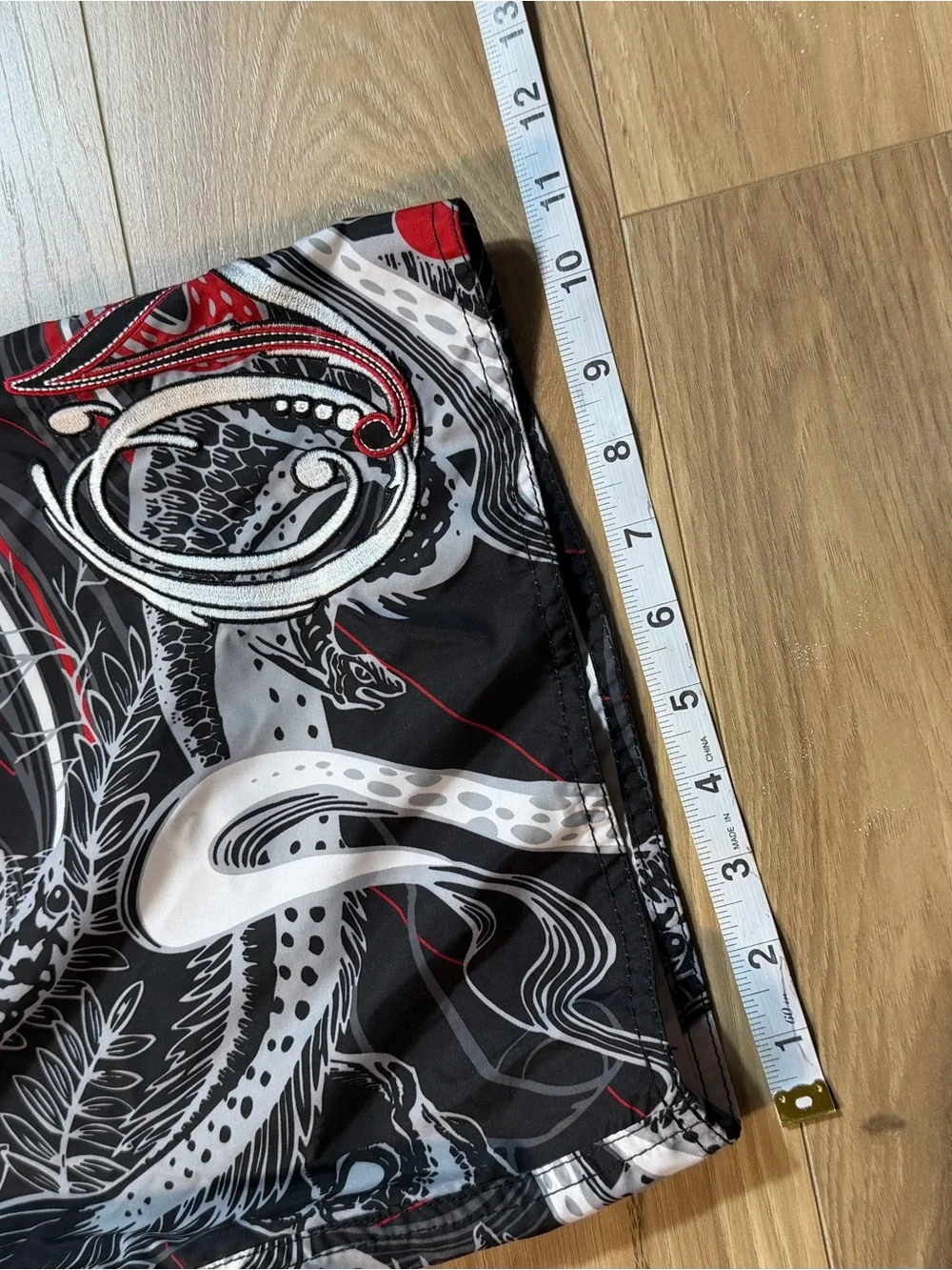 O'Neill black board shorts with white and red